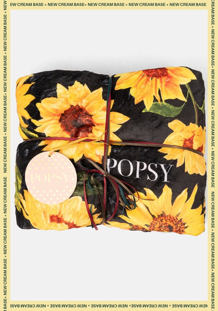 Front view of Black Sunflower Print Plush Throw Blanket (Pop-Under), black sunflower print plush blanket.