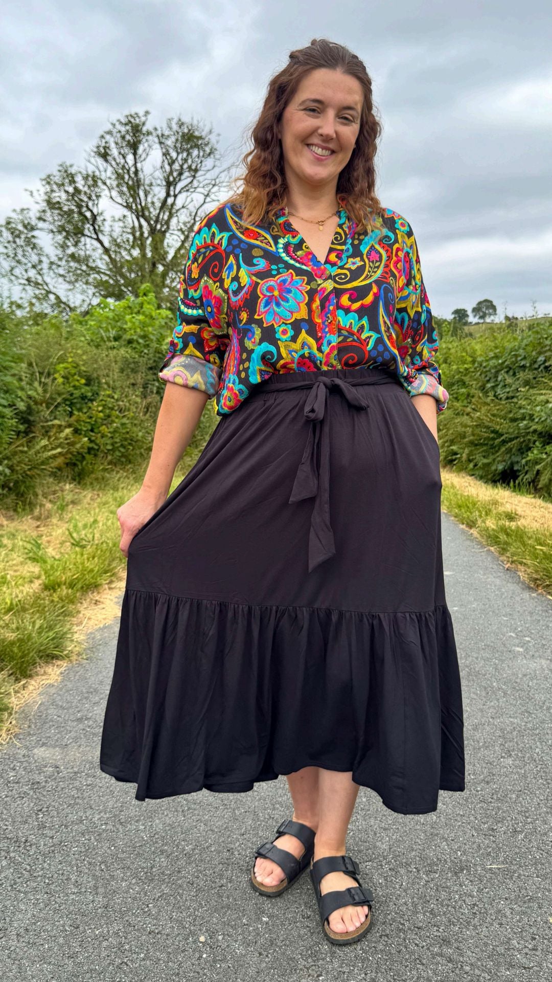 Third angle of Bina Black Tiered Hem Viscose Midi Skirt