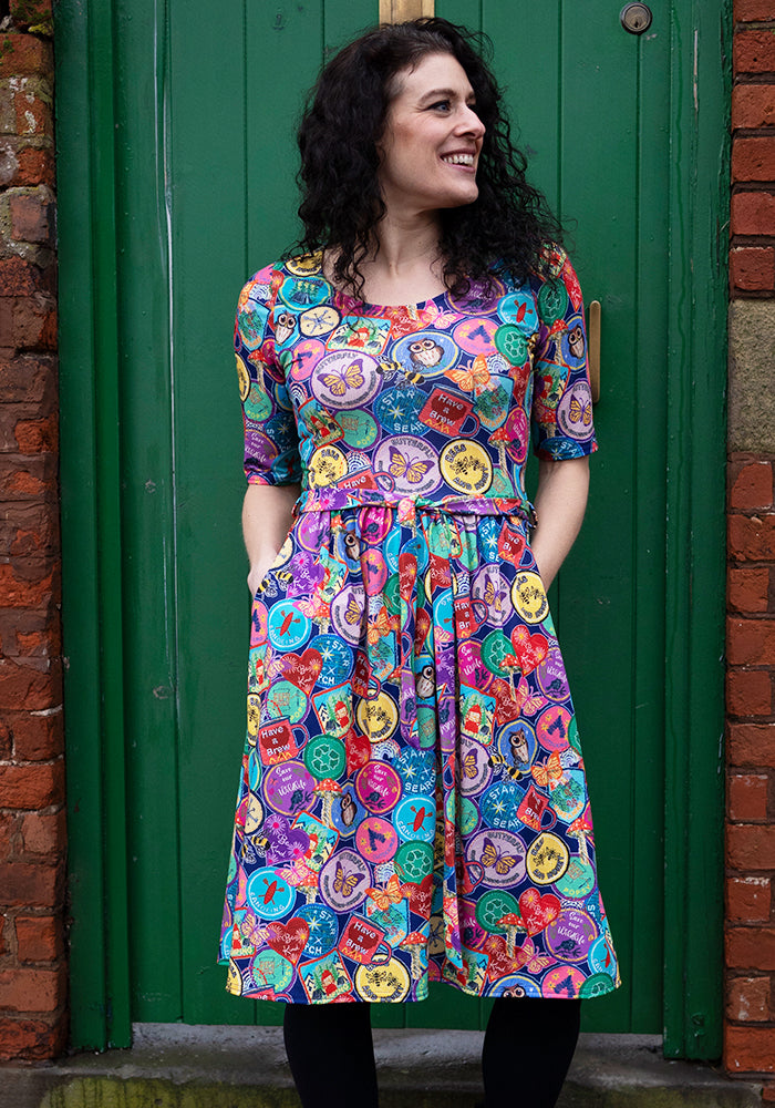 Front view of Annika Badges Print Dress, our jersey is a smooth, stretchy fabric known for its comfort and ease.