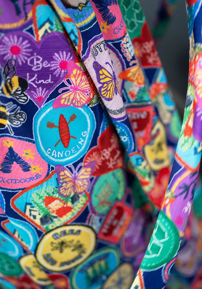 Tenth angle of Annika Badges Print Dress, our jersey is a smooth, stretchy fabric known for its comfort and ease.