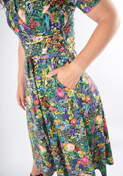 Colourful floral midi dress with hand in pocket