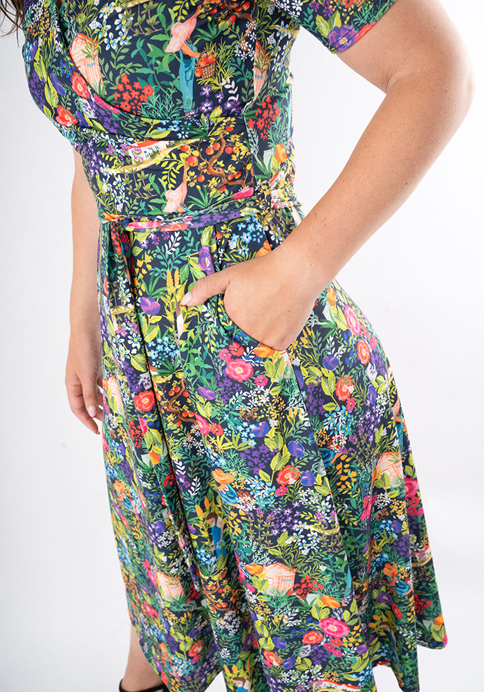 Colourful floral midi dress with hand in pocket