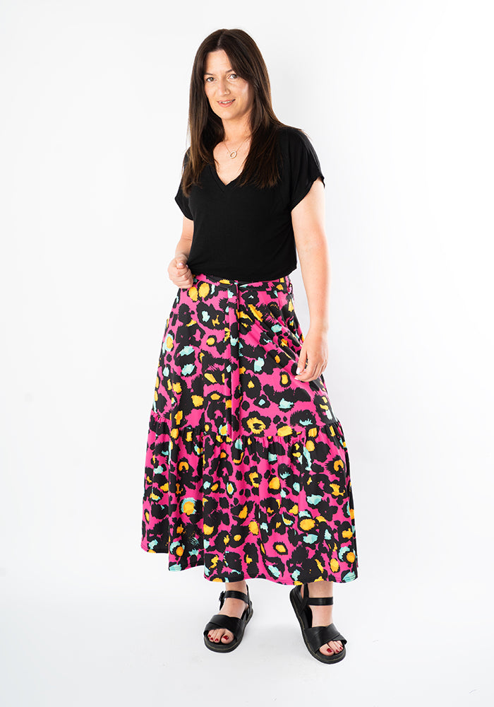 Front view of Aramis Pink Animal Print Tiered Hem Jersey Midi Skirt