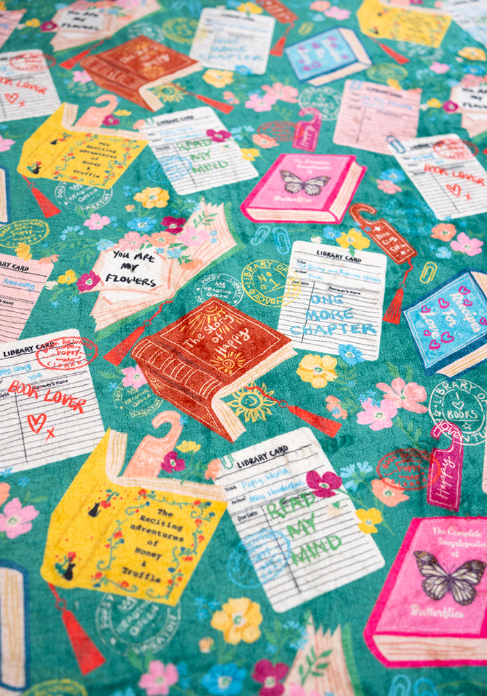 Third angle of Teal Library Books Print Plush Blanket (Pop-Under), teal Library Book print plush blanket from Popsy Clothing.