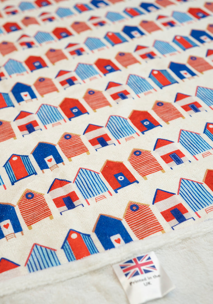 Third angle of Beach Hut Print Jumbo Bath Sheet, a jumbo bath sheet with a classic beach holiday vibe.