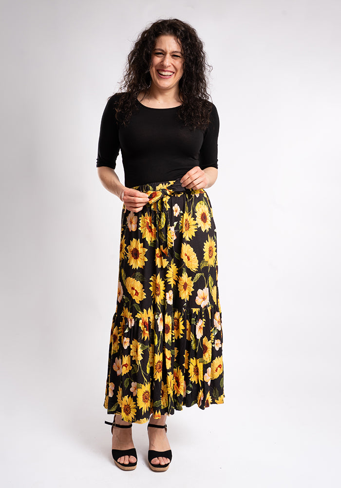 Third angle of Bina Sunflower Print Viscose Tiered Hem Midi Skirt