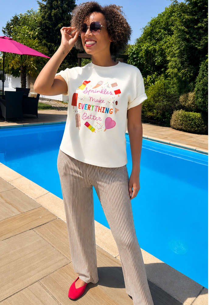 Third angle of Sprinkles Graphic Print T-Shirt (Cream), a cream tee with "Sprinkles Make Everything Better" positive slogan.