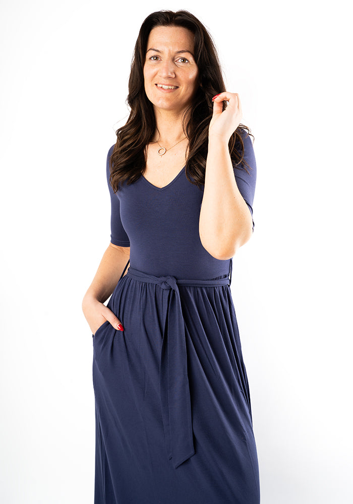 Woman wearing a navy blue maxi dress close up picture