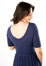 Woman wearing a navy blue maxi dress from behind