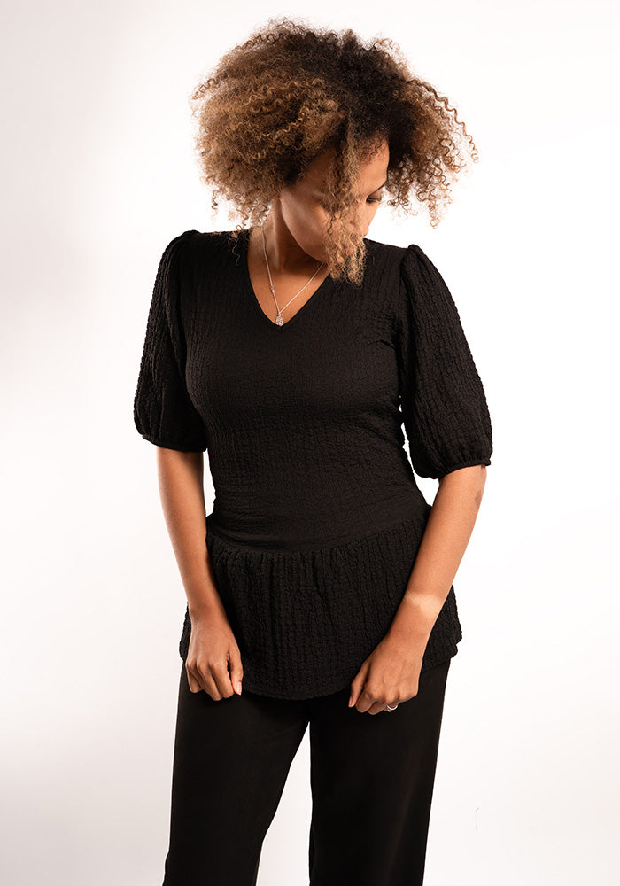 Front view of Deia Black Peplum Top