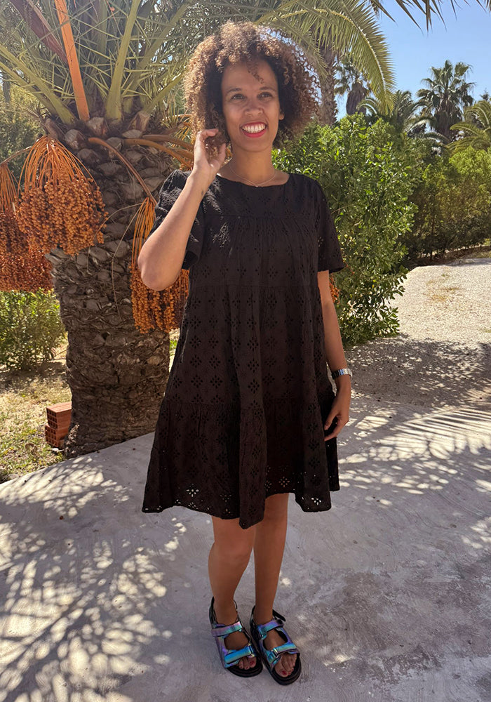 Third angle of Emblyn Black Broderie Anglaise Cotton Tiered Dress