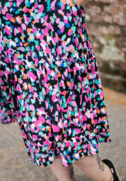 Colourful animal patterned dress skirt with a brick wall background