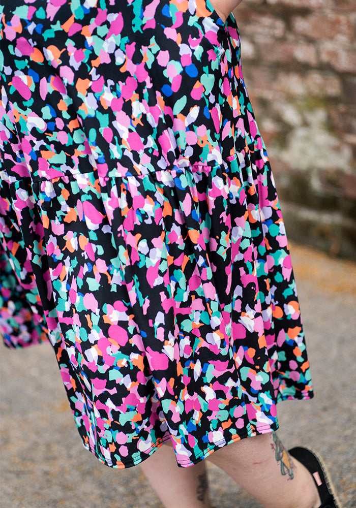 Colourful animal patterned dress skirt with a brick wall background