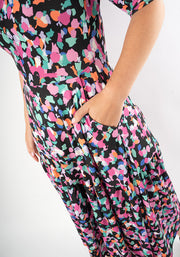 Multicolored patterned animal print dress with hand in pocket 