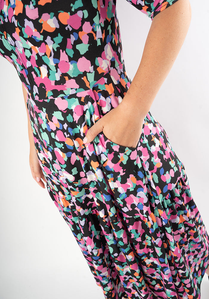 Multicolored patterned animal print dress with hand in pocket 