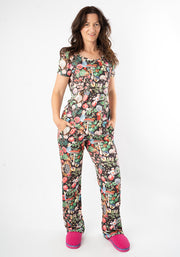 Woman wearing a colourful wonderland print pyjama set