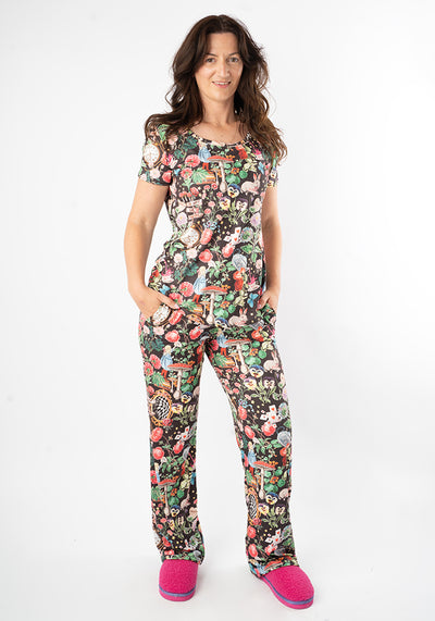 Woman wearing a colourful wonderland print pyjama set