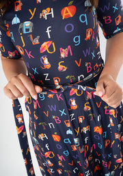 Navy blue midi dress with colourful alphabet phonics pattern