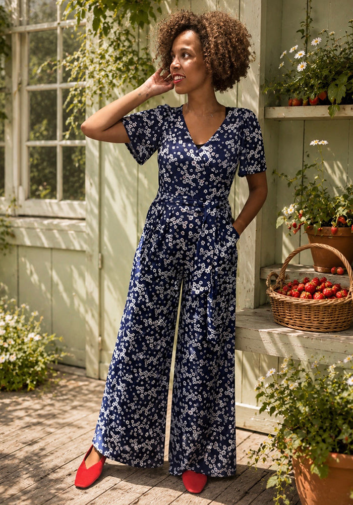 Front view of Lia-May Navy Ditsy Flower Print Full Length Jumpsuit, a full length navy jumpsuit with a ditsy flower pattern.