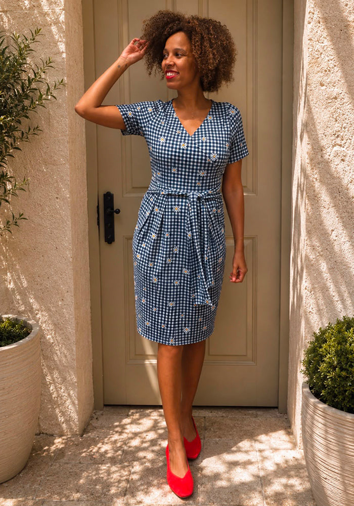 Front view of Maven Navy and White Gingham Daisy Print Dress, a navy and white gingham dress with daisy pattern.