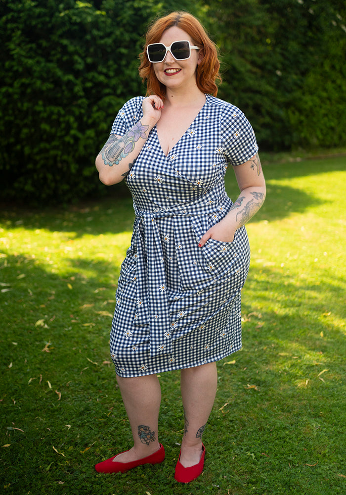 Third angle of Maven Navy and White Gingham Daisy Print Dress, a navy and white gingham dress with daisy pattern.