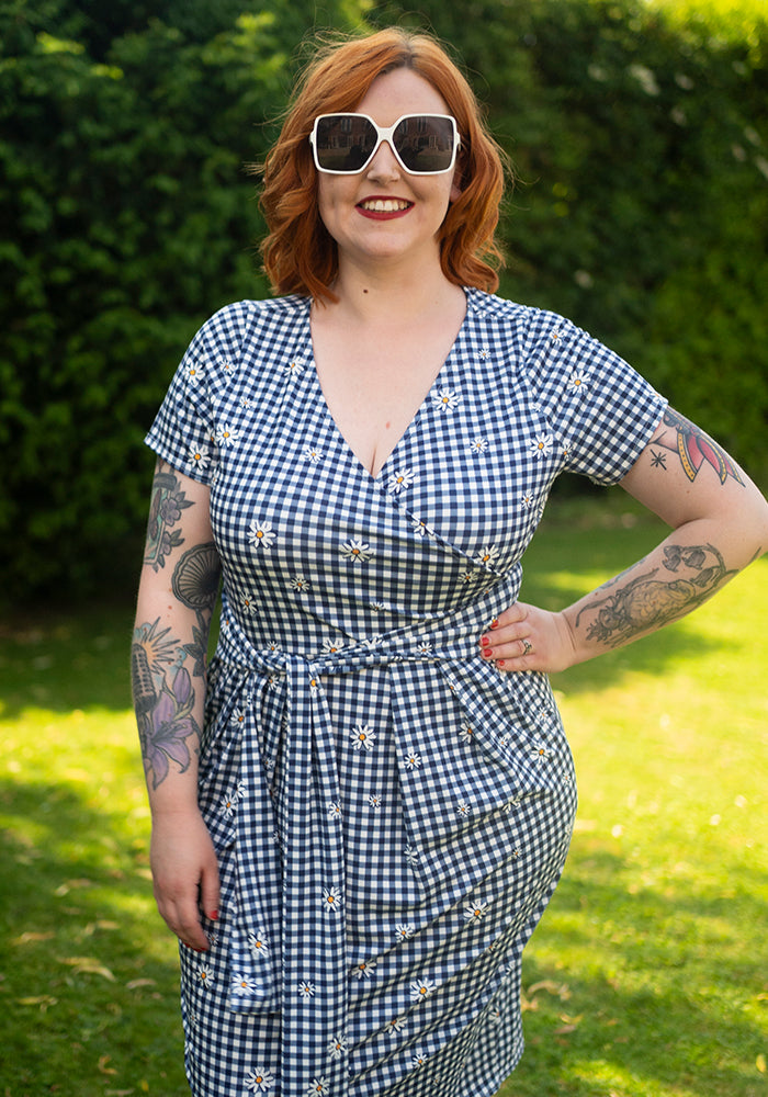 Second angle of Maven Navy and White Gingham Daisy Print Dress, a navy and white gingham dress with daisy pattern.