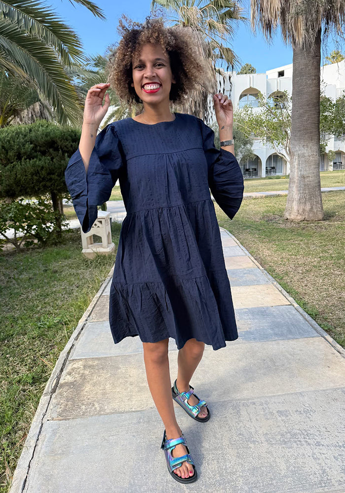 Front view of Mayliss Navy Textured Woven Cotton Tiered Dress