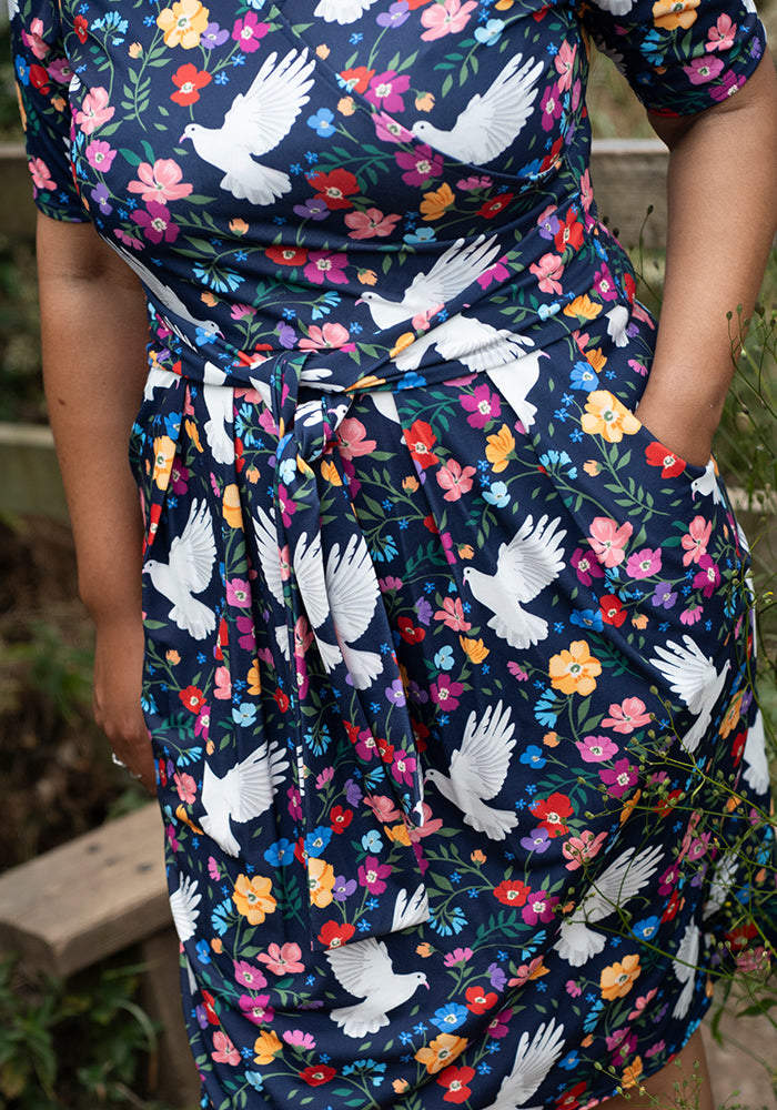 Dress with floral and dove pattern worn by a person