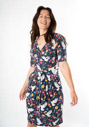 Woman wearing a floral dress with bird pattern