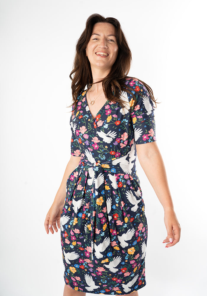 Woman wearing a floral dress with bird pattern