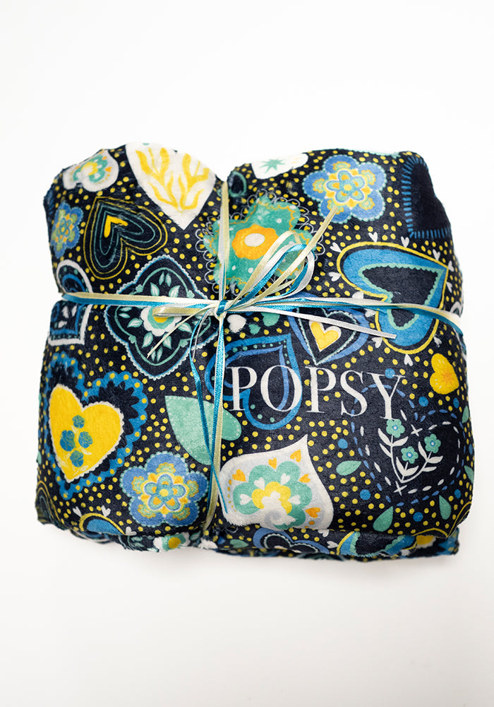 Front view of Pop-under Folklore Hearts Print Plush Blanket