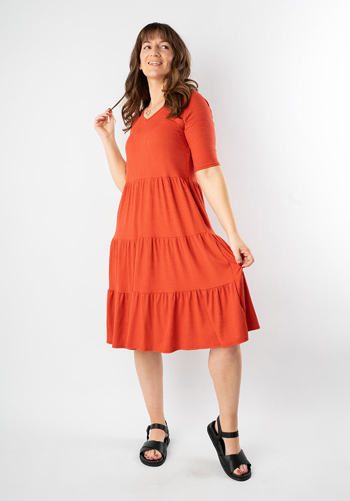 Front view of Reed Rust Rib Brush Tiered Hem Dress
