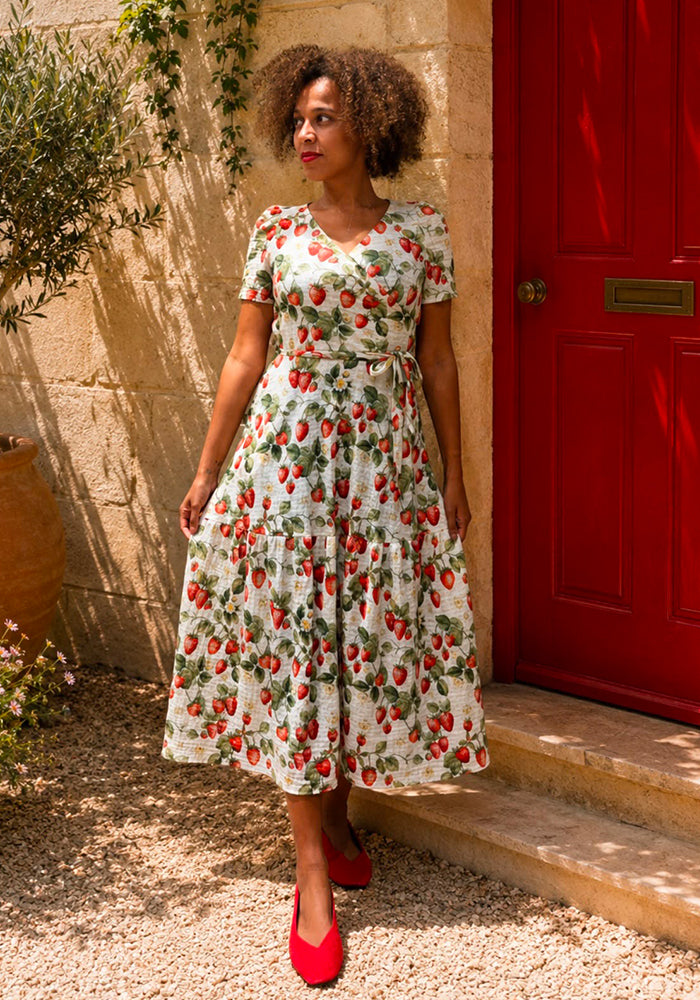 Front view of Rella Cream Strawberries Print Tiered Hem Midaxi Dress, cream based Midaxi dress with wrap neck and tiered hem.