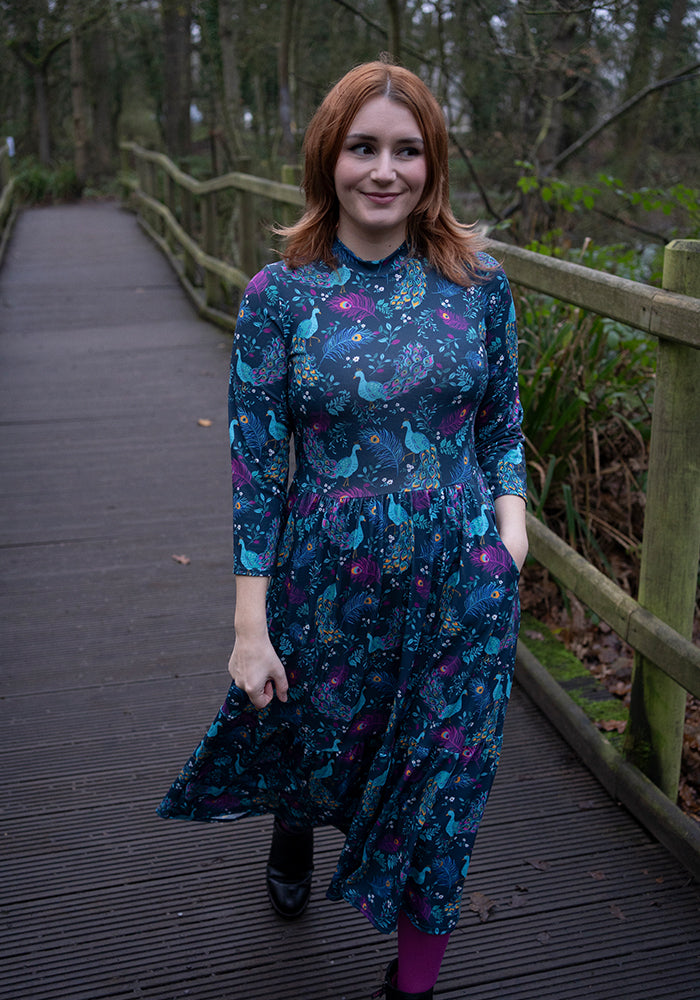 Front view of Rosalie Peacock Print Tiered Hem Midi Dress