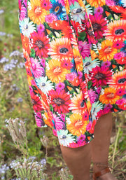 Colourful floral dress hidden cat pattern in a natural setting