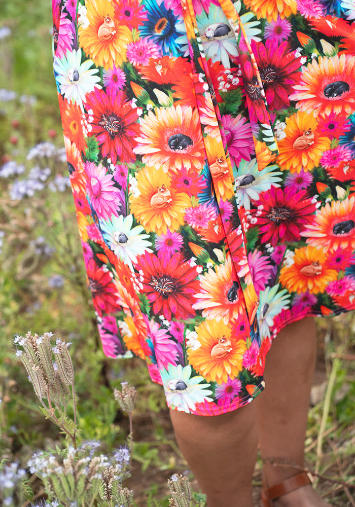 Colourful floral dress hidden cat pattern in a natural setting