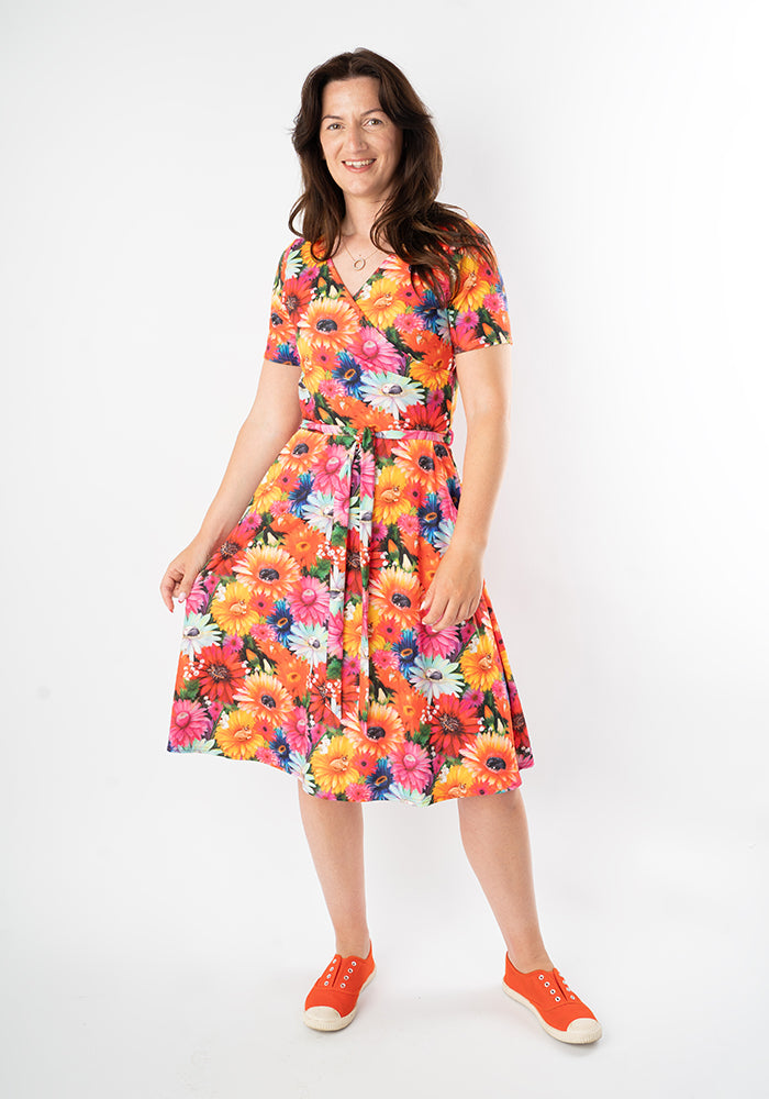 Woman wearing a colorful floral and cat print dress