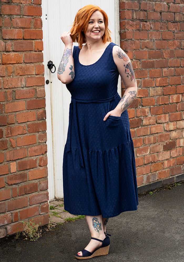 Front view of Shae Navy Oval Textured Tiered Hem Midi Dress