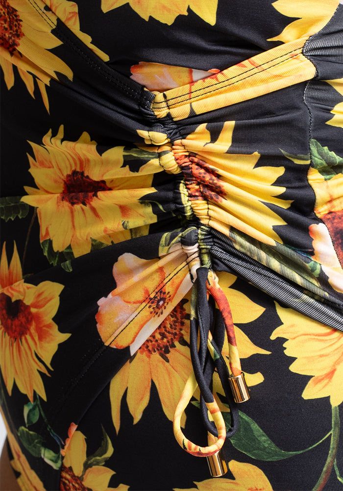 Close-up of a sunflower swimsuit with yellow flowers on a black background