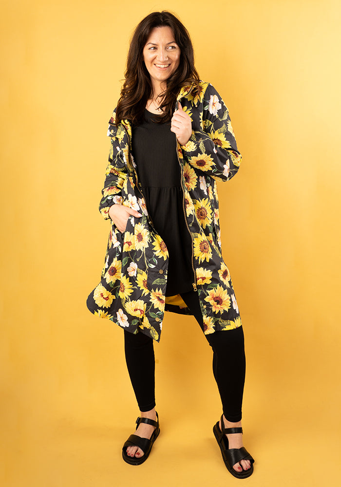 Front view of Black Sunflower Print Popsy Coat

Woman wearing the Black Sunflower Print Coat with hood, adjustable waist and large front pockets.