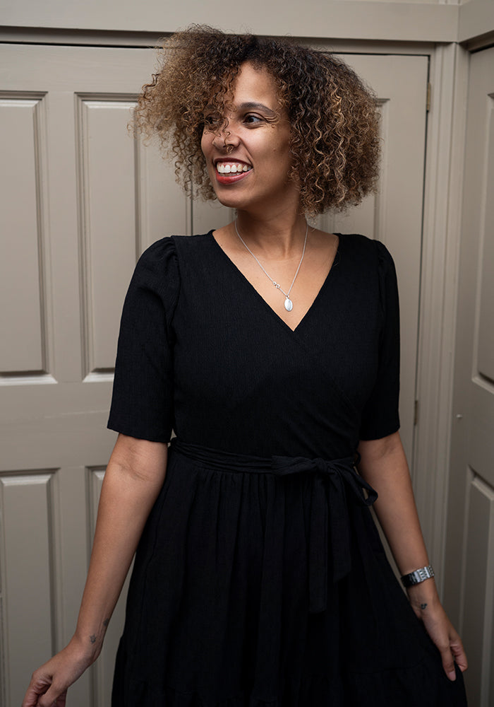 Third angle of Tate Black Oval Textured Tiered Hem Midi Dress
