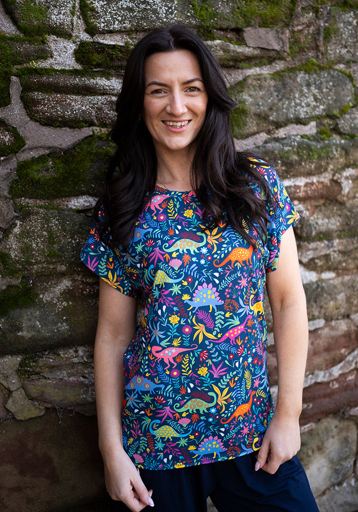 Front view of Tess Teal Dinosaur Print Extended Shoulder Top