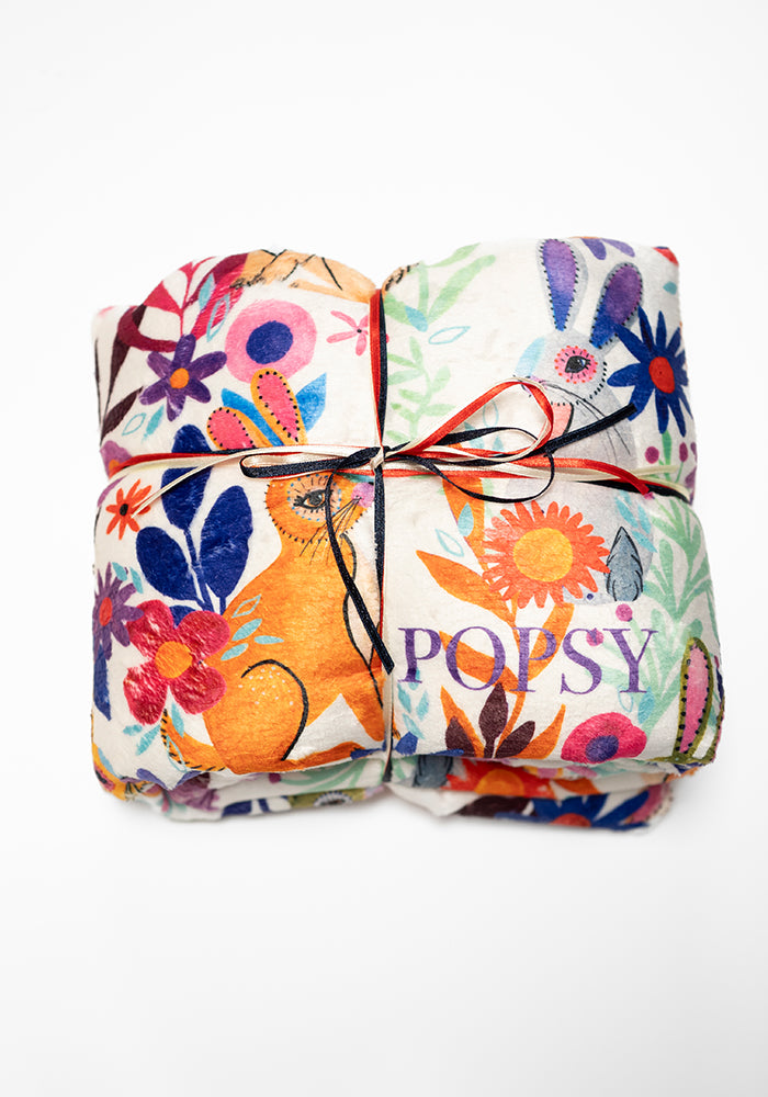 Front view of Garden Bunnies Cream Print Pop-under Plush Blanket