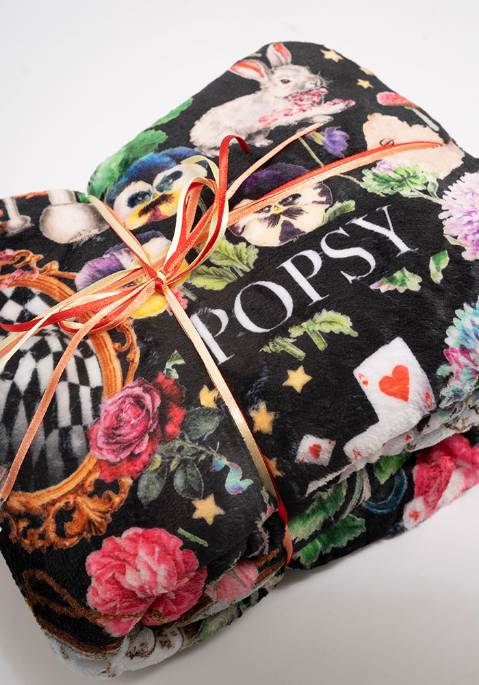 Front view of Wonderland Print Plush Throw Blanket (Pop-Under)