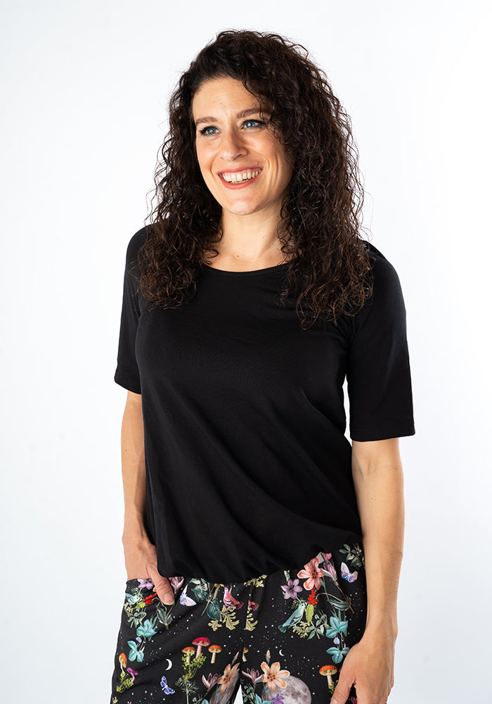 Third angle of Zola Solid Black Cotton Bubble Hem Top