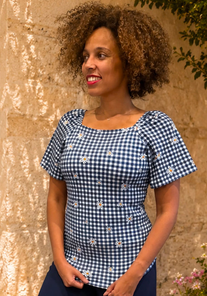 Front view of Navy and White Gingham Daisy Print Top, a navy &amp; white top with a daisy print.