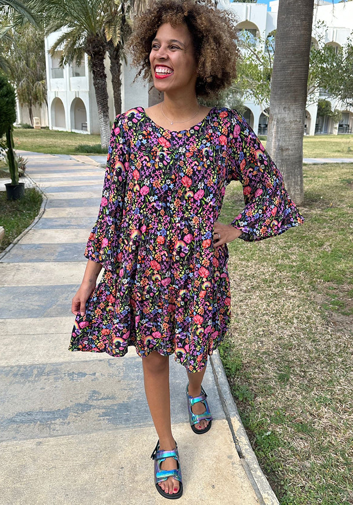 Front view of Every Garden Rainbow Print Woven Tiered Hem Dress