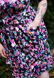 woman wearing a colourful animal patterned printdress with a blurred background
