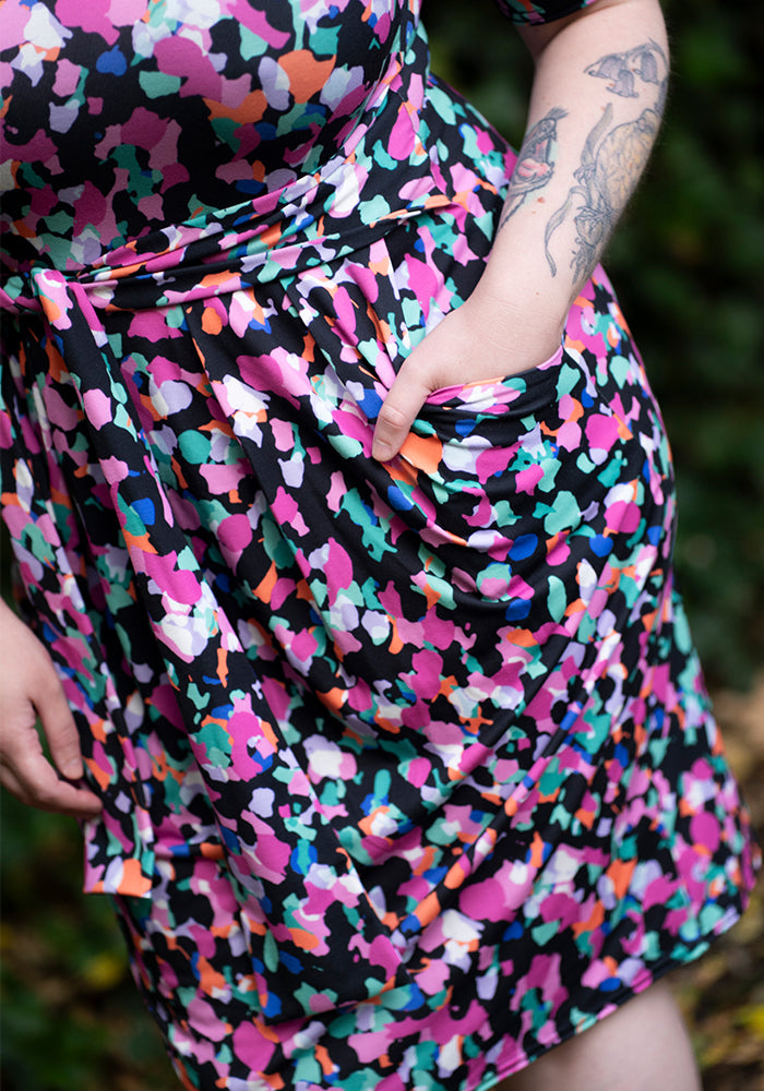woman wearing a colourful animal patterned printdress with a blurred background
