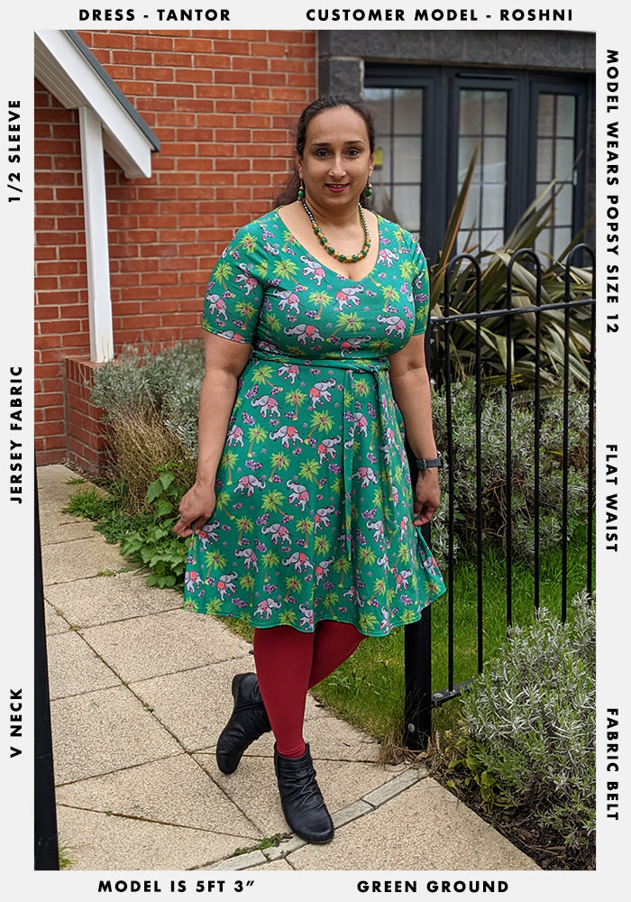 A customer model picture of Tantor. Roshni is standing against a metal fence. She is 5ft 3" and wearing a size 12.